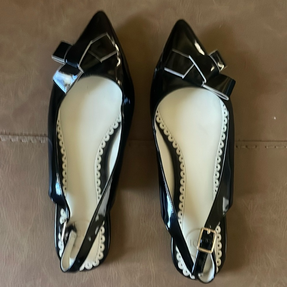1901 black patent leather slingback flats with cute bow detail.